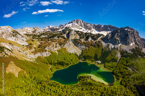 Wallpaper Mural Drone view of Trnovačko Jezero, stunning heart-shaped lake near Montenegro-Bosnia border, embraced by Maglić, Volujak and Bioć peaks, dramatic panoramic alpine scenery. Torontodigital.ca