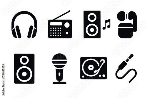 Audio equipment icon set. Vector black symbols of headphones, radio, speaker, and microphone