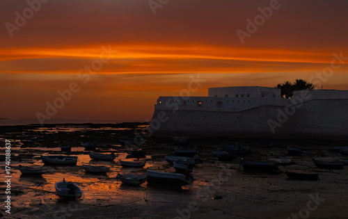 Sunset in Cadiz harbor with Casillo Santa Calalina in background.