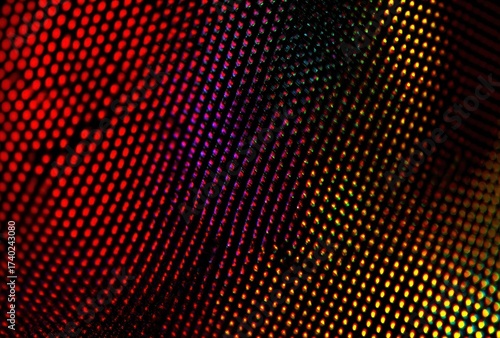 Abstract close-up of a fabric or textured surface with a complex pattern of colored dots