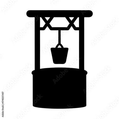 Black silhouette of a water well with a bucket suspended above it
