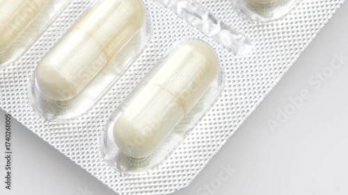 Blister pack with long cylindrical tablets macro closeup of a generic medicine package detail showing vitamins supplements OTC drugs pharmaceutical healthcare supplies simple concept symbol, nobody