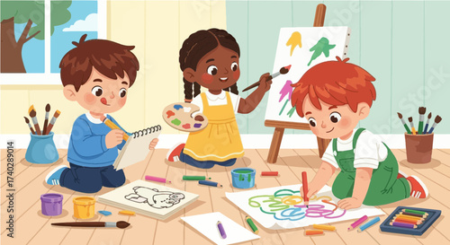 Three children are painting and drawing pictures on the floor in a bright and creative classroom scene
