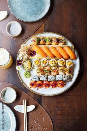 Large sushi plate with different types of rolls in warm and pastel tones. Asian food. Oriental Brazilian restaurant.