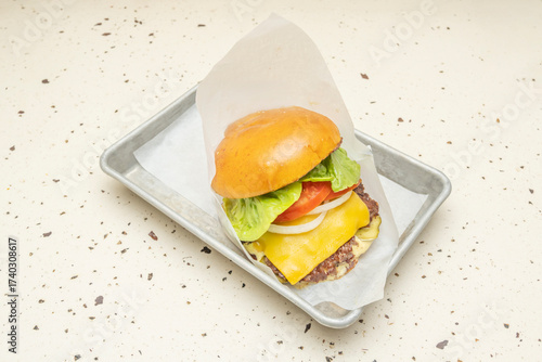 фотографія Gourmet burger with a blend of three meats, melted Havarti cheese, garden tomato