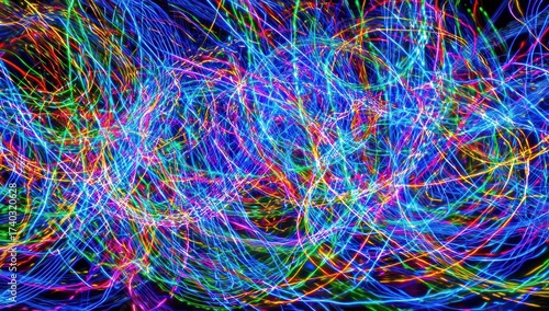 Abstract image of blurred, colorful light trails against a dark background