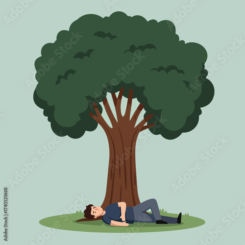 Person sleeping under a large tree