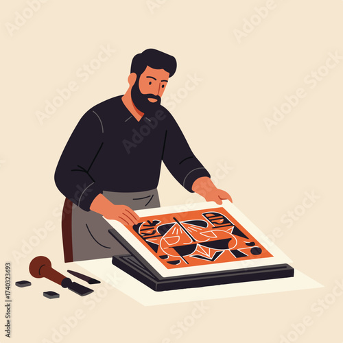 Bearded artist carefully places linocut print on ink-covered block for transfer
