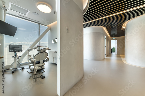 Modern dental office interior with reception desk, patient chairs, treatment rooms and professional equipment. Bright clean environment designed for healthcare and dentistry services, including x-ray 