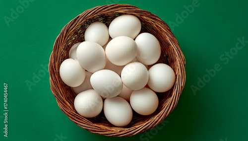 A basket of white eggs on a green background