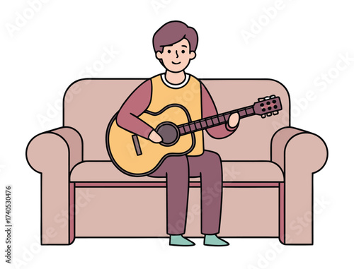 Young man playing acoustic guitar sitting on a comfortable sofa