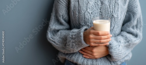 Woman holding a glass of milk. Dairy lactose intolerance health care concept. Generative AI technology.