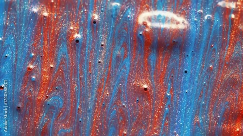 An abstract macro of swirling blue and red paints. Bubbles add depth