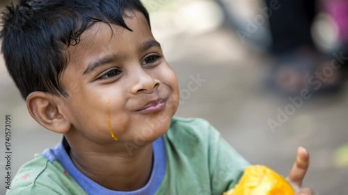 Joyful Indian child eating fresh mango, representing simple happiness in daily life