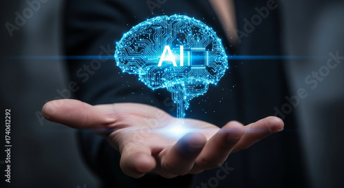 A human hand holding a glowing blue holographic brain with 'AI' text, symbolizing artificial intelligence and technological innovation.