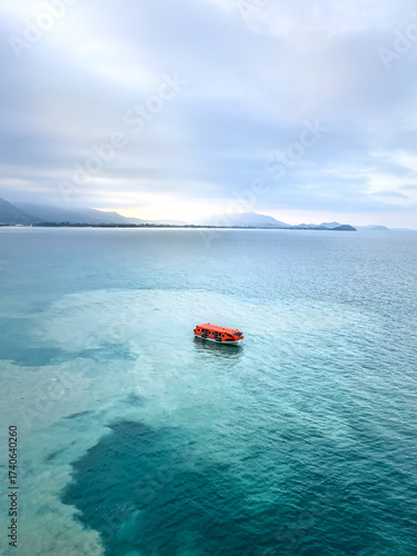 Orange Lifeboat in Blue Water with sandy Patterns Coast of Thailand