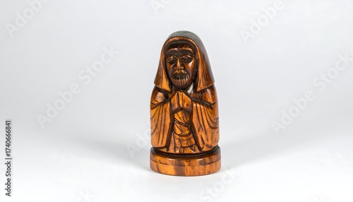 Small wooden carving of a hooded figure