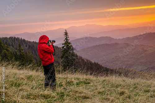 View of a woman photographing the sunrise