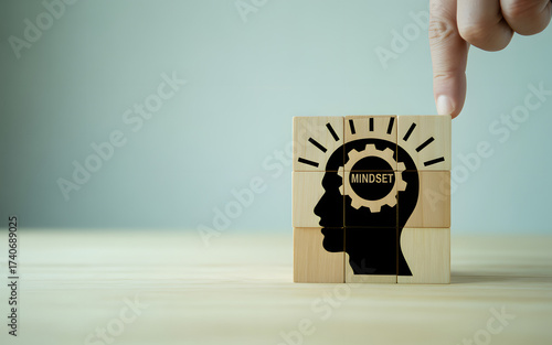 Conceptual image of mindset featuring wooden blocks with a head silhouette and gear, symbolizing mental clarity