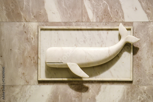 A three-dimensional mural carved into a wall of a whale