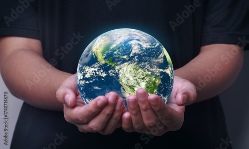 Fototapeta Naklejka Na Ścianę i Meble -  Blue planet earth on hands.  a symbol of environmental conservation, responsibility towards the world and sustainability of natural resources. Elements of this image furnished by NASA