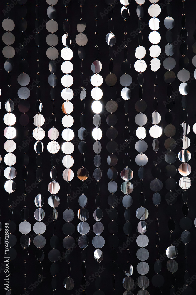 Fototapeta premium Abstract background with flickering and glittering silver metallic particles or sequins on the wall