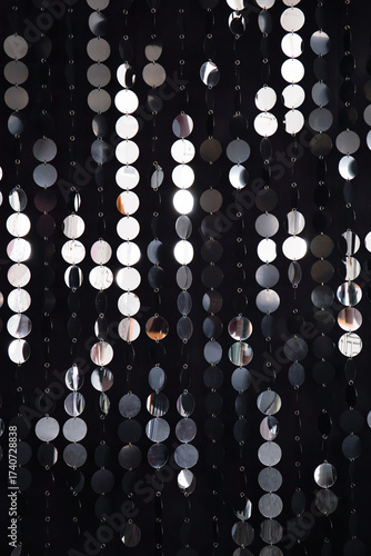 Abstract background with flickering and glittering silver metallic particles or sequins on the wall