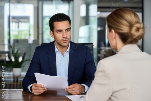 A man and woman sitting at a table in an office