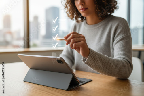 Woman sitting at a table using a tablet