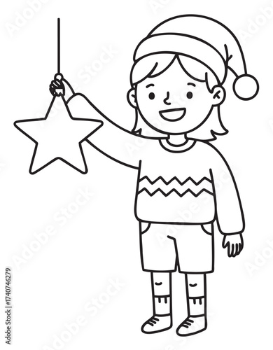 Smiling young caucasian female child wearing a santa hat holds a star-shaped ornament while dressed in a sweater and shorts, embodying festive joy.
