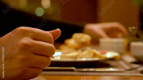 A Moment of Enjoyment: Savoring Delicious Food and Engaging in Conversation Over a Meal at a Cozy Dinner Table