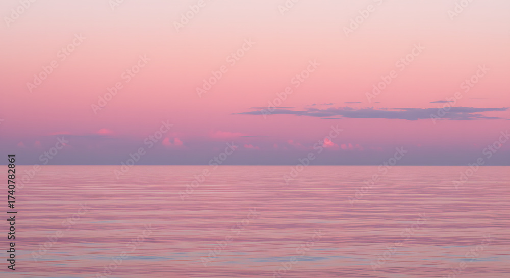 Fototapeta premium Serene ocean view at sunset with pastel pink sky and calm waters 