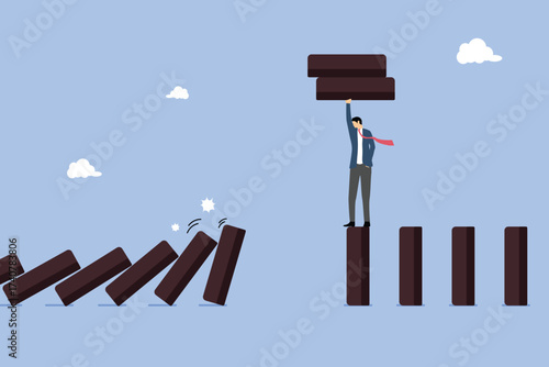 Businessman remove dominoes to avoid collapse, risk management crisis prevention, reduce opportunity or chance of failure, escape failure situation, disaster protection or proactive thinking to avoid.