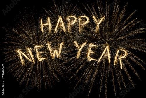 Golden fireworks illuminate a Happy New Year message against a black backdrop, celebrating the new year with sparkling festive cheer