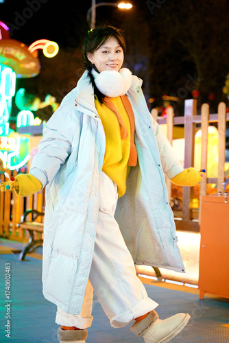 Oriental beauty taking photos on the city streets at winter night