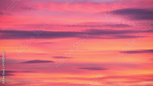 A vibrant sunset with shades of pink, purple, and orange blending in the sky. Soft clouds create a serene atmosphere, perfect for relaxation and reflection.