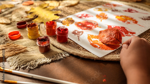 Fototapeta Naklejka Na Ścianę i Meble -  Autumn leaf art project with paint and brushes