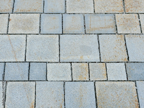 Wallpaper Mural Granite pavement with rough texture, varying gray tones, and natural discoloration. Close-up. Copyspace. Torontodigital.ca