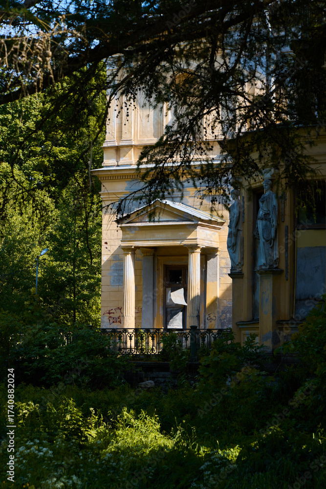 Naklejka premium Discovering Abandoned Architectural Beauty Nestled Amidst Lush and Vibrant Nature