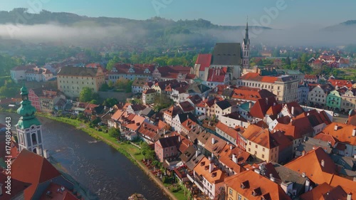 aerial perspective captures the historic UNESCO World Heritage site of Český Krumlov, Czech Republic. The footage showcases the picturesque old town with its distinctive red tiled roofs, the iconic Če