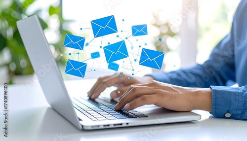Person working on a laptop sending and receiving emails, digital communication