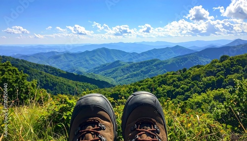 Scenic mountain view with hiking boots, landscape and blue sky in nature