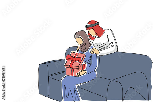 Single continuous line drawing an arab woman sitting on the sofa while opening a gift box. Opening a surprise gift from the beloved partner. Present. Surprise. One line design vector illustration