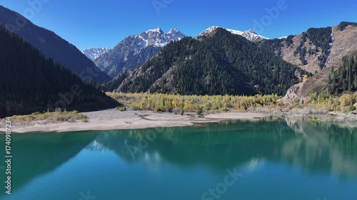 A quadcopter view of Lake Issyk (Almaty Region, Kazakhstan) and the mountain river flowing into it on an autumn morning.