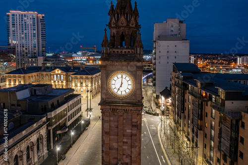 Aerial photograph of the illuminated Albert Memorial Clock in Belfast, captured at twilight.
