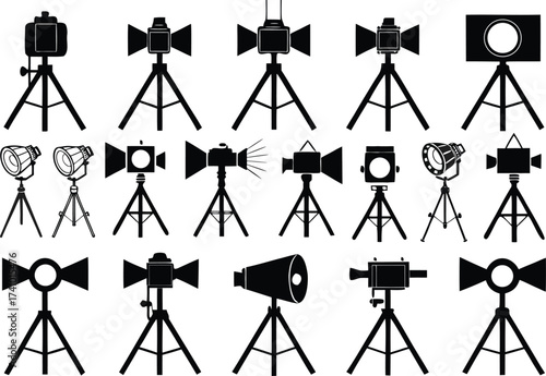 Collection of black studio lights and cameras on tripods spotlight photography