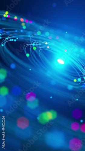 Futuristic looping animation with glowing light trails and colorful particles spinning around a radiant center, evoking a sense of space, energy, and digital flow.