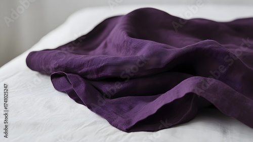 Elegant purple linen fabric draped over white linen, soft and textured material
