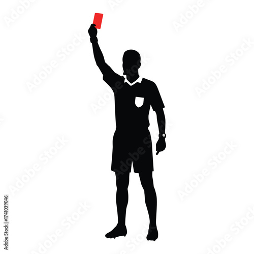 Silhouette of a soccer referee displaying a red card during a match