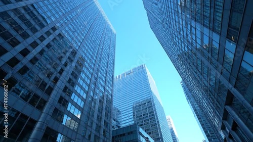 Wallpaper Mural Looking up at towering modern skyscrapers against a clear blue sky, emphasizing urban architecture and scale. Torontodigital.ca
